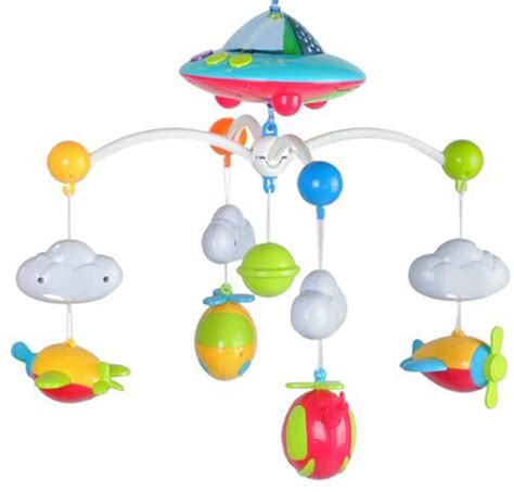 Een vrolijk gekleurde muziekmobiel met diverse hangende figuurtjes boven een babybedje.