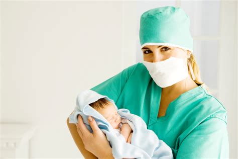 Vroedvrouw begeleidt een barende vrouw in een ziekenhuisomgeving.