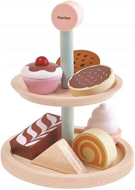 Illustratie van een kind dat met de speelgoed bakkerij set speelt, met kleurrijke koffiebroodjes en bakgerei.