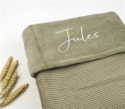 Een baby die slaapt onder een Jollein deken met berenprint.