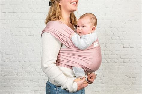 baby in een blauwe ByKay draagdoek, met de gezichtje naar de drager gericht