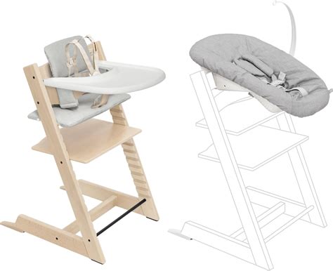 Illustratie van een baby in de Stokke Newborn set aan een eettafel, die interactie heeft met de ouders.