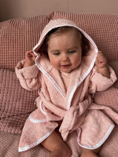 Baby met een zachte badjas met naam