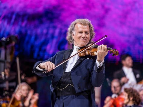 Een foto van André Rieu die viool speelt tijdens een concert