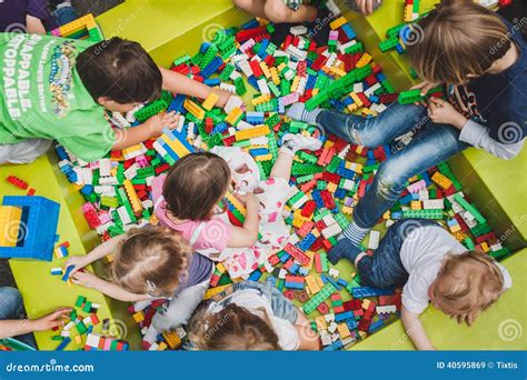 Kinderen die spelen met LEGO Ninjago sets, met diverse ninja-figuren en voertuigen.