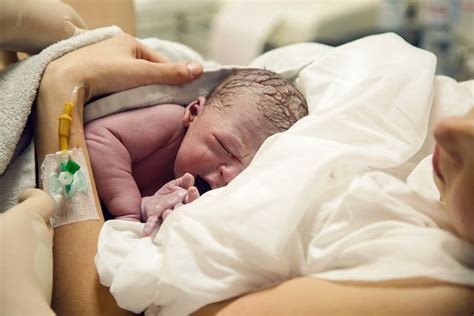 Baby op de borst van de moeder voor huid-op-huidcontact direct na de geboorte